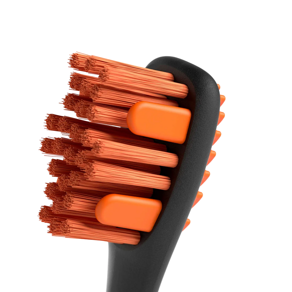 BrushMate Premium Toothbrush with Biteblock,"Close-up of toothbrush head with orange bristles and bite blocks"