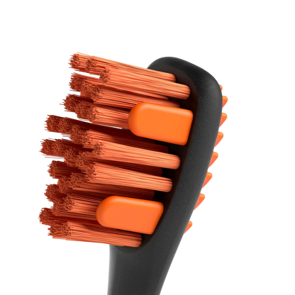 BrushMate Premium Toothbrush with Biteblock,"Close-up of toothbrush head with orange bristles and bite blocks"