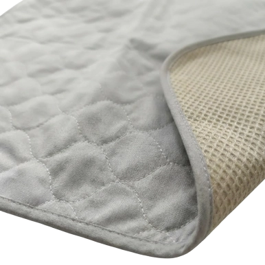 Puppywarmer Whelping Box Pad,"Gray quilted pad with textured underside and folded corner"