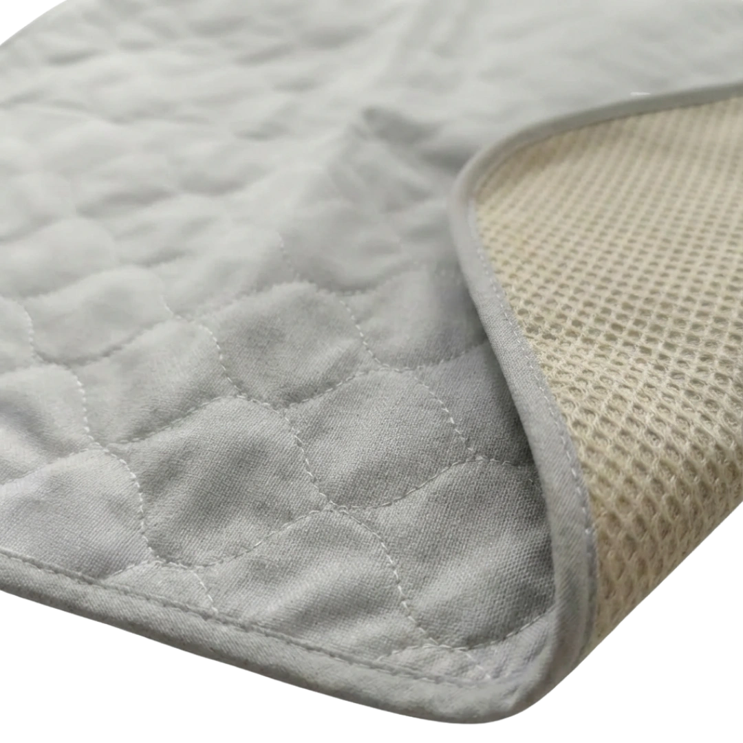 Puppywarmer Whelping Box Pad,"Quilted pad with folded corner showing textured underside"