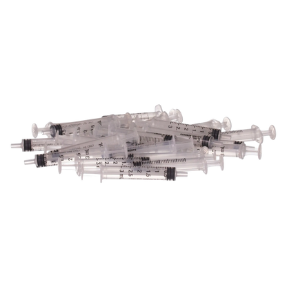 Small Syringes without Needles,"Pile of clear plastic syringes without needles"