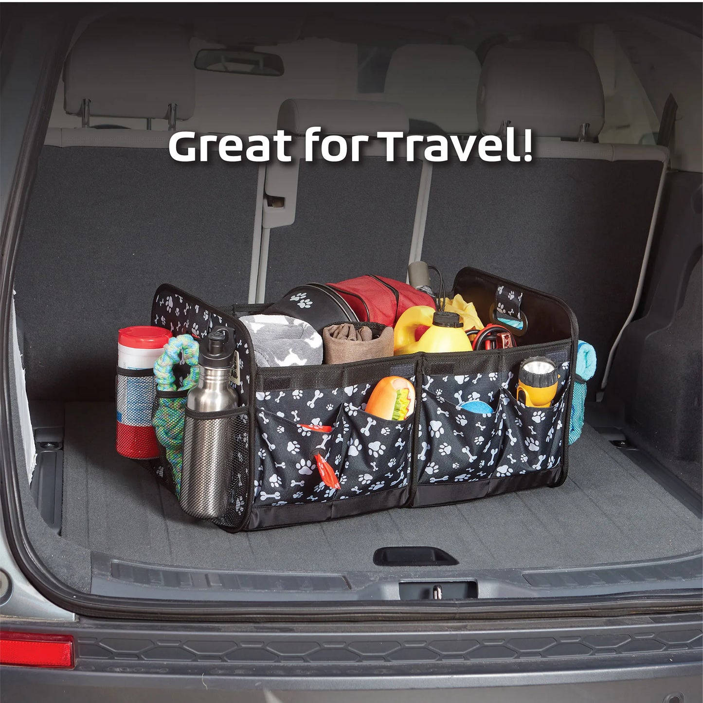 Dogssentials Collapsible Storage Organizer,"Black paw print trunk organizer filled with pet travel items"
