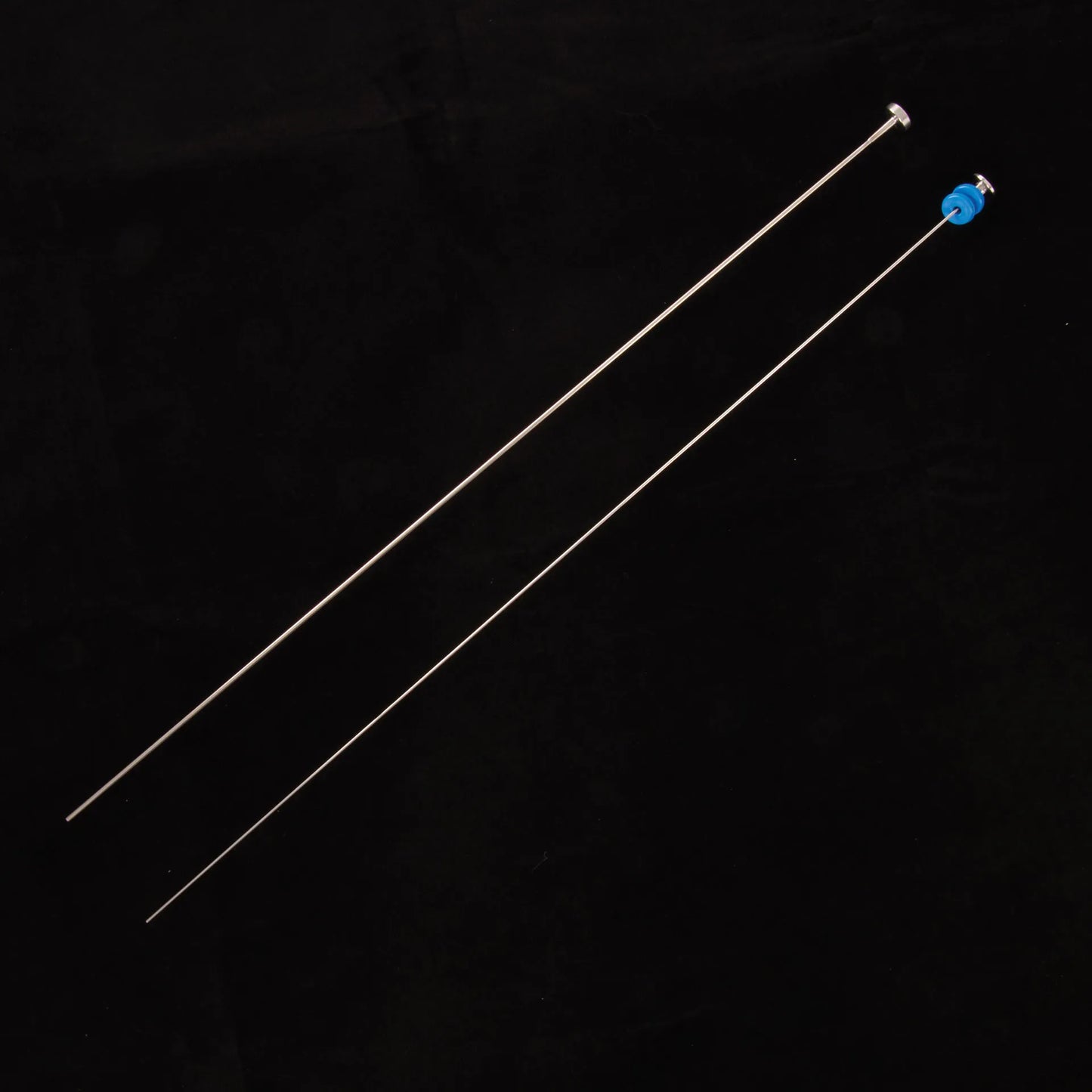 ET Syringe gun,"Two long metal rods, one with blue cap"