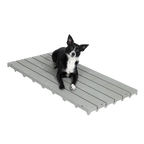 Kennel Deck®,"Small black and white dog lying on gray slatted deck panel"