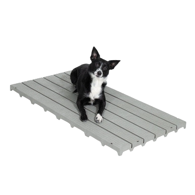 Kennel Deck®,"Small black and white dog lying on gray slatted deck panel"