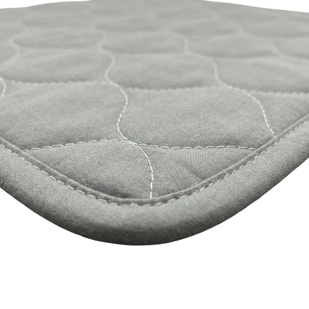 Puppywarmer Whelping Box Pad,"Close-up of quilted pad corner with stitched edge"