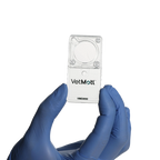 VetMotl Sperm Separation Device,"Clear rectangular device held between blue gloved fingers"