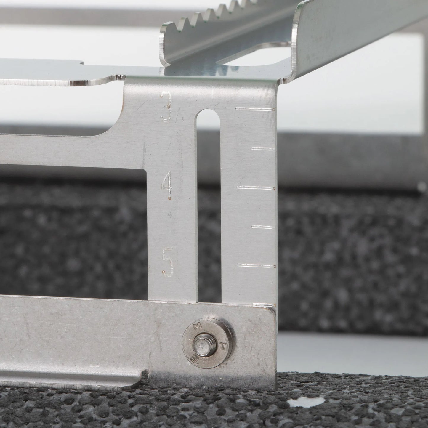 Floating Straw Rack,"Metal rack side detail with height adjustment slots"