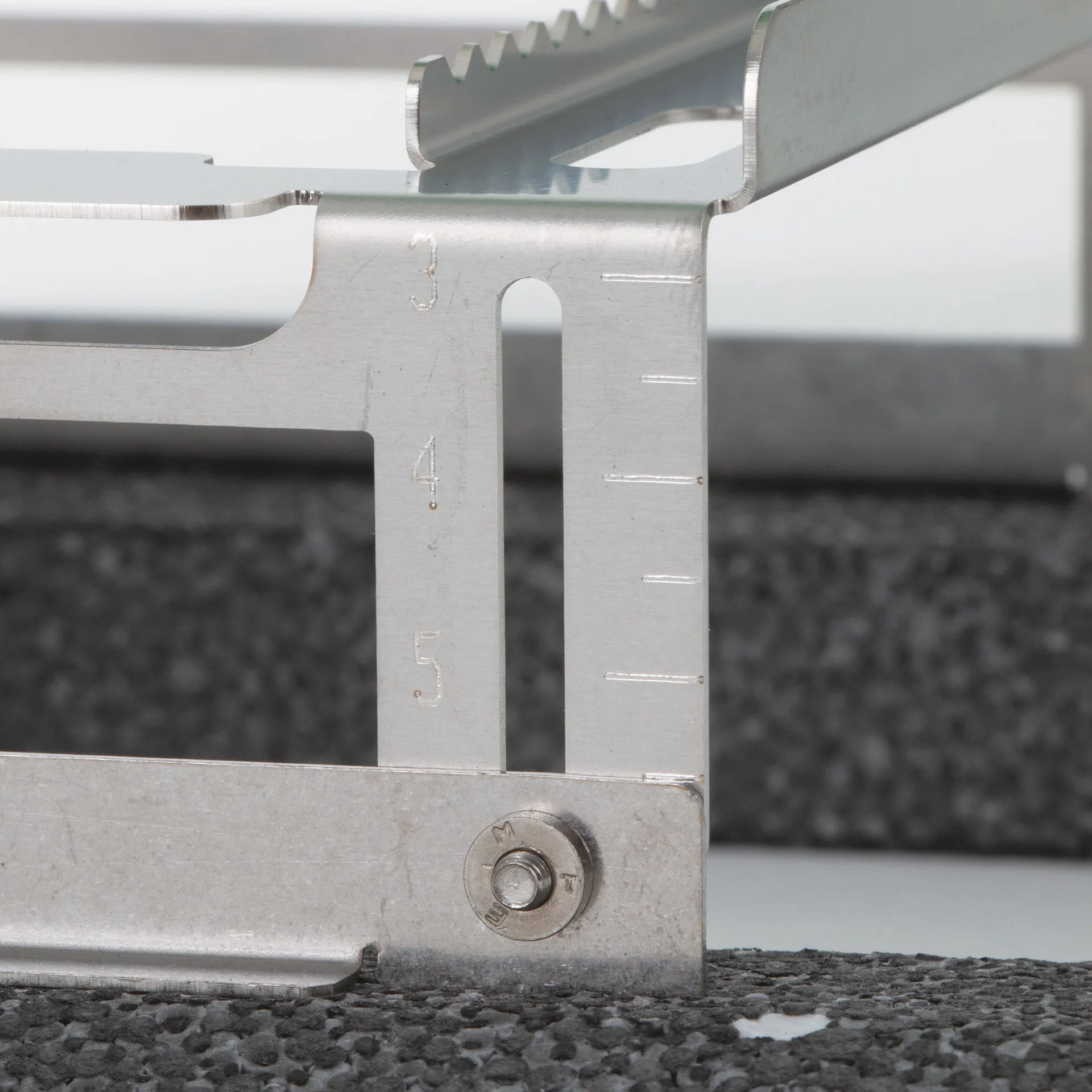 Floating Straw Rack,"Metal rack side detail with height adjustment slots"