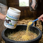 Comfort Quik™,"Open supplement tub pouring powder into horse feed with blue scoop"