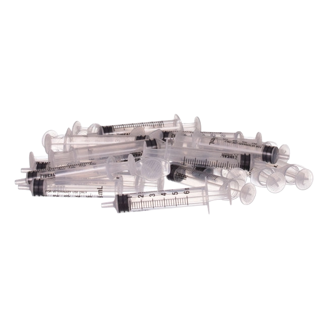 Small Syringes without Needles,"Scattered pile of clear plastic syringes without needles"