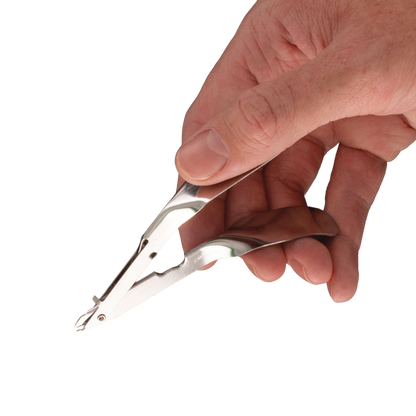Skin Stapler,"Metal stapler held in hand, close-up view"