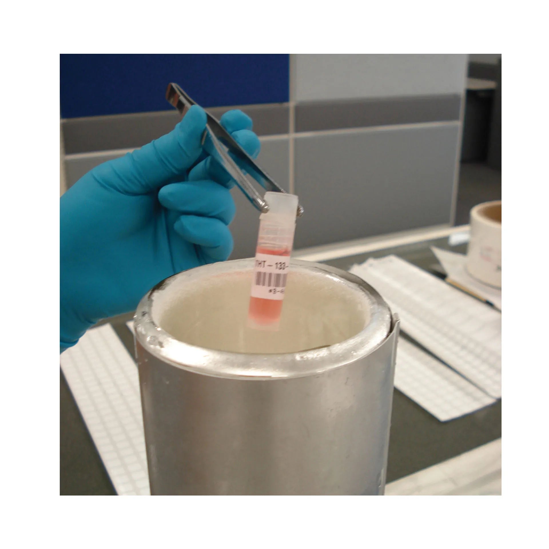 Lab Label Printer and Self-Laminating Cryogenic Polyester Labels,"Gloved hand placing labeled vial into cryogenic container"