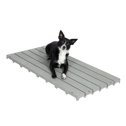 Kennel Deck®,"Gray slatted kennel deck with dog lying on top"