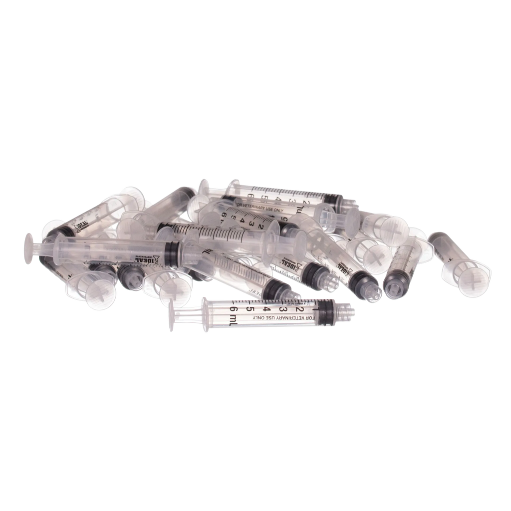 Small Syringes without Needles,"Pile of clear plastic syringes without needles"