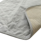 Puppywarmer Incubator Pee Pad,"Quilted gray pad with corner folded to show textured underside"