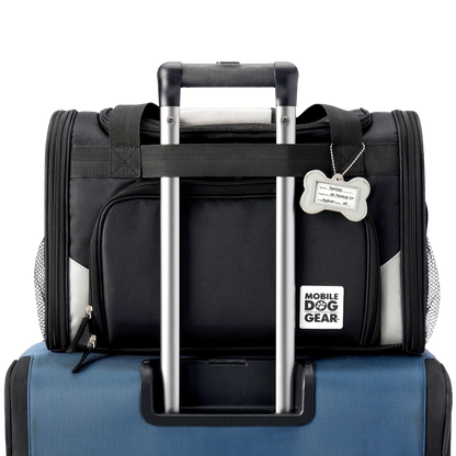 Mobile Dog Gear Pet Carrier Plus,"Black pet carrier attached to luggage handle with bone-shaped ID tag"