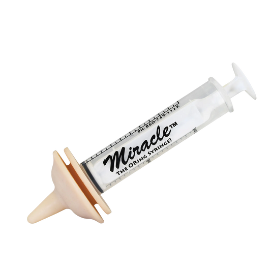 The Miracle Nipple® for Puppies,"Clear syringe with attached beige feeding nipple"