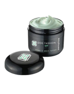 Semplice Leave-in Lotion,"Open black jar with pale green lotion and lid beside it"