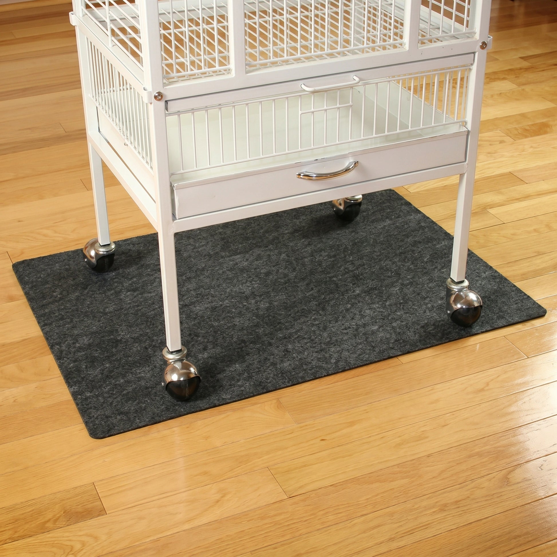 Bird Cage Mat,"Dark rectangular floor mat under bird cage"
