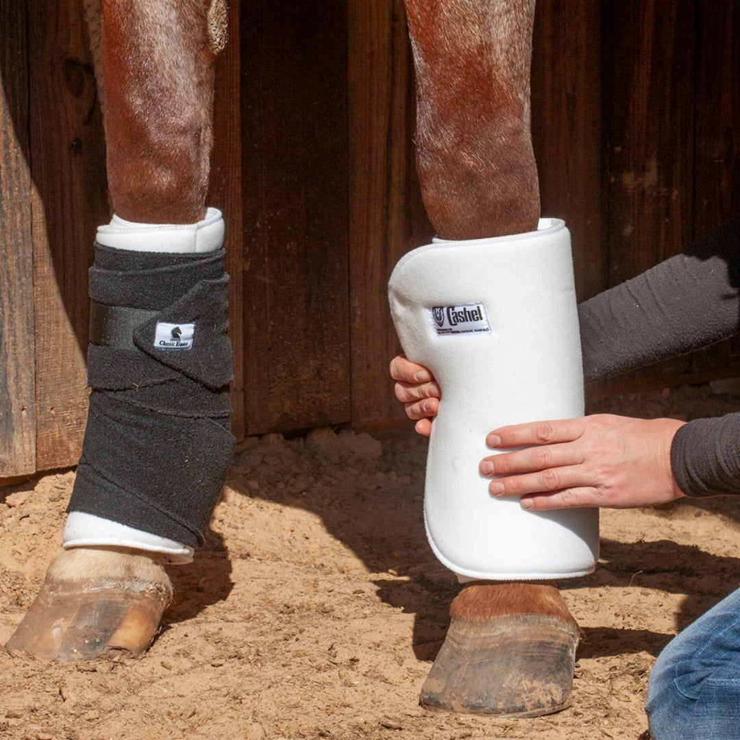 Cashel No Bow Bandage Wrap,"White leg wrap being applied to horse leg"